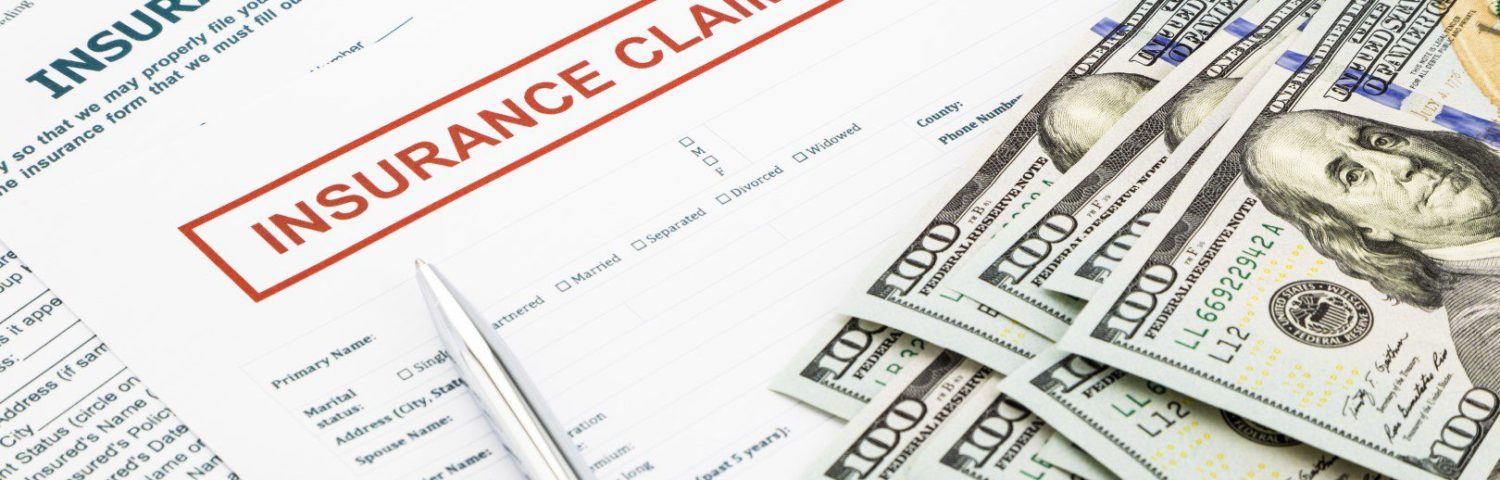 Insurance Claim Forms with a Stack of Money